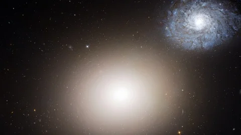 Elliptical galaxy slow rotating with flying stars Stock Footage