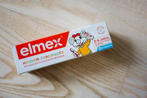 Elmex children's toothpaste packaging for ages 2-6 on wooden surface Stock Photos