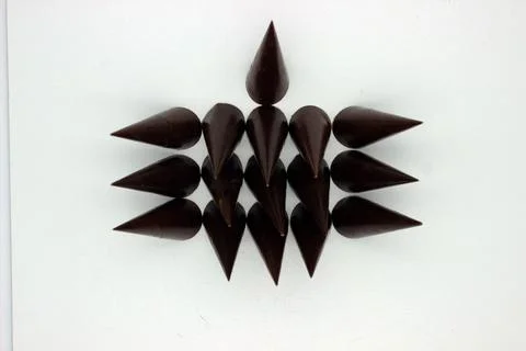 Elongated chocolates on white background Stock Photos