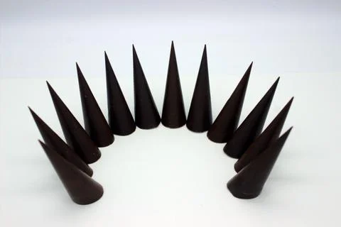 Elongated chocolates on white background Stock Photos
