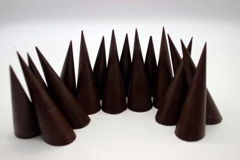 Elongated chocolates on white background Stock Photos