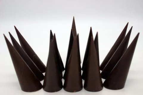 Elongated chocolates on white background Stock Photos