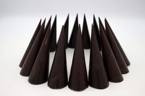 Elongated chocolates on white background Stock Photos