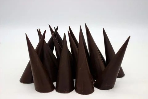 Elongated chocolates on white background Stock Photos