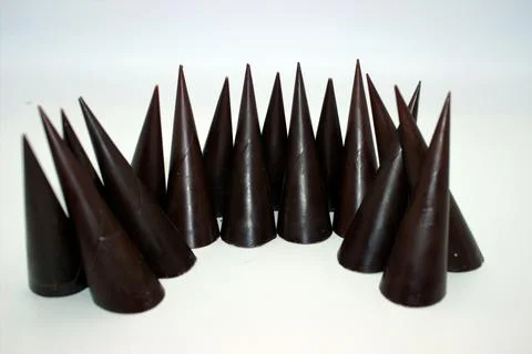 Elongated chocolates on white background Stock Photos