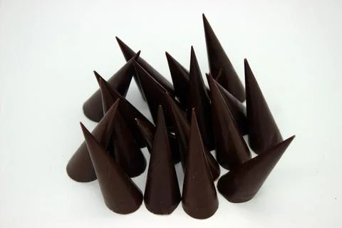 Elongated chocolates on white background Stock Photos