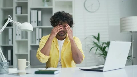 Eluctant annoyed worker. Sad and disheveled businessman sitting at computer desk Stock Footage 235486361
