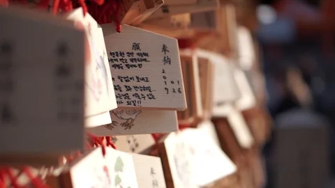 Ema with handwritten prayers hanging from a wall at a Shinto shrine temple 스톡 동영상 94843787