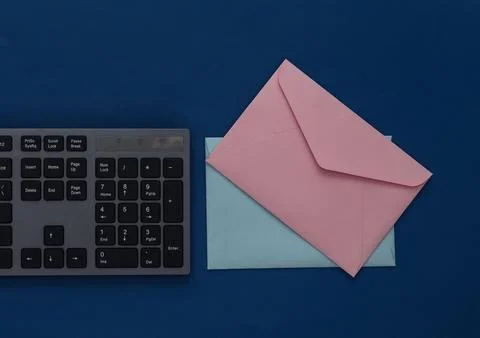 Email. PC keyboard and envelopes on a classic blue background. Stock Photos