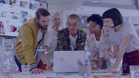 Email pinging, creative team gathering around laptop, pointing and matching Stock Footage 332428469