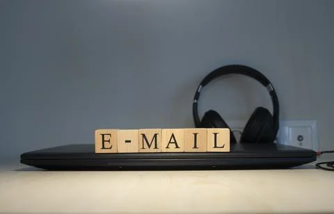 Email word written on the background computer and headset concept. Closeup. Stock Photos