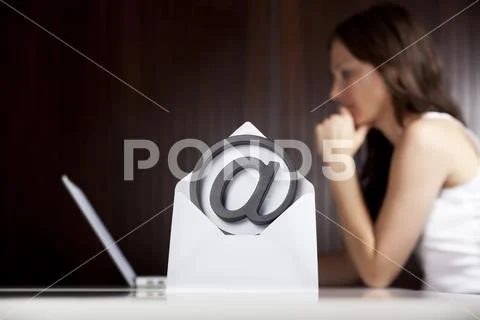 Emailing concept: At letter with woman and laptop. Stock Photos