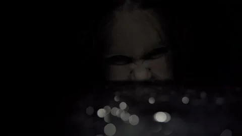 Emale face appear from dark instantly. Scary video of girl in darkness Stock Footage 160403752