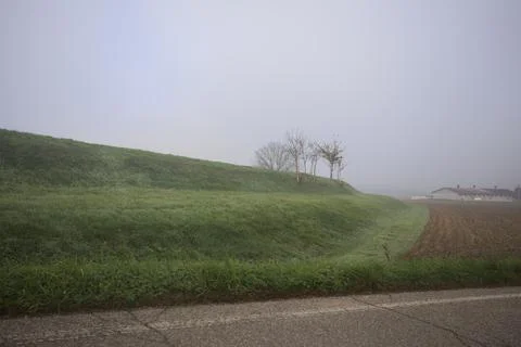 Embankment with a road bordering fields Stock Photos
