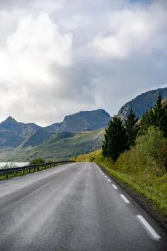 Embark on a breathtaking road trip with this image of a scenic coastal road w Stock Photos