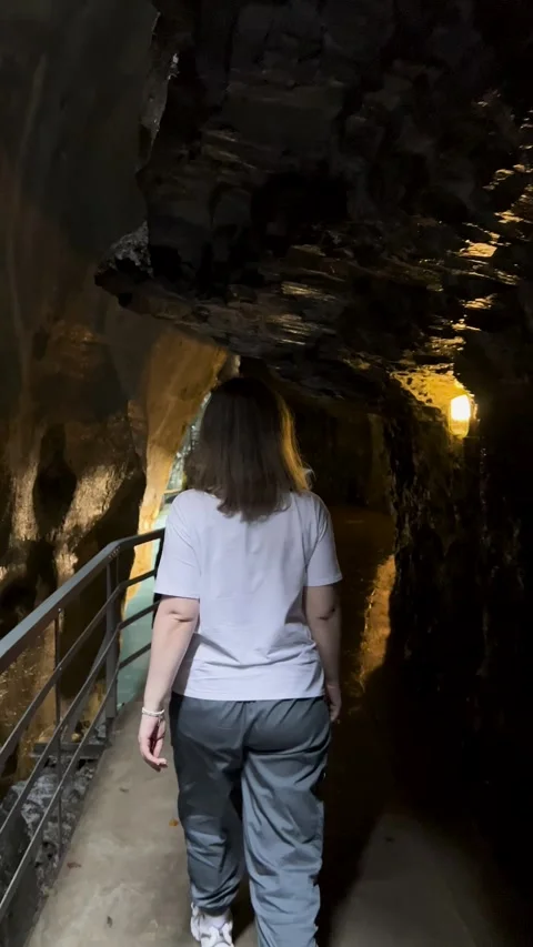 Embarking on an Adventure to Explore a Cave Pathway Beautifully Surrounded by Stock Footage 304779054