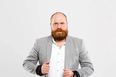 Embarrassed man in gray jacket Embarrassed man with beard in gray jacket w... Foto stock