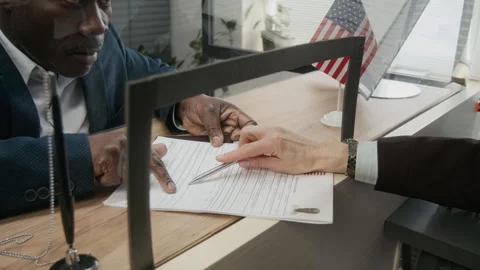 Embassy Clerk Requesting Businessman to Correct Mistake in Visa Application Stock Footage 331517291