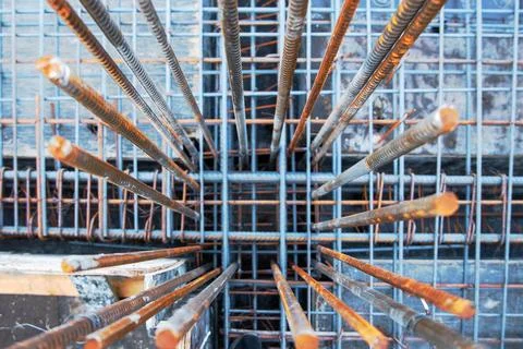 Embedded frame for a column made of steel reinforcement protrudes from the main Stock Photos
