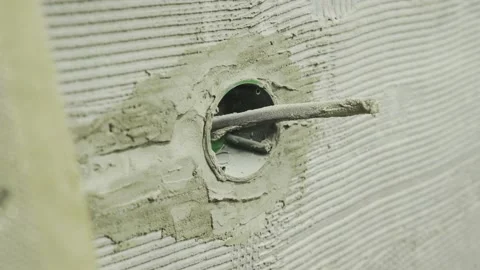 Embedded socket in the wall during renovation with a protruding wire Stock Footage 144277871