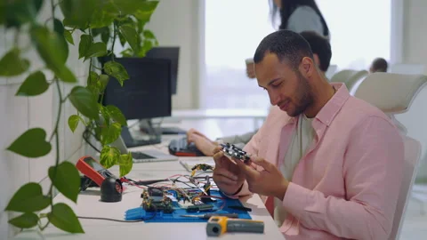 Embedded Systems Programmer Utilizing a Multimeter Measuring Instrument. Man Video stock 244201236