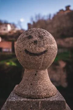 Embedded within the rugged rock, a face emerges, its contours and expressio.. Stock Photos