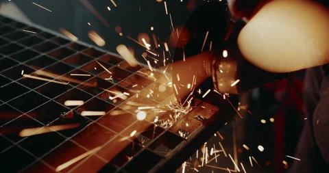 Ember bursts of Sparks explode as angle grinder cuts through metal Stock Footage 265259634