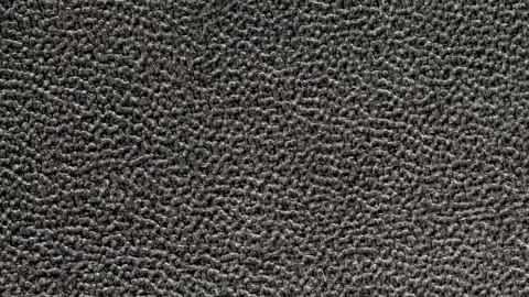 Embossed black old surface under artificial leather, rotating 動画素材 240647415