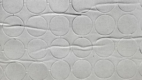Embossed circular texture pattern on crumpled white paper surface with tact.. Stock Photos