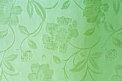 Embossed floral pattern on light green textured fabric Stock Photos