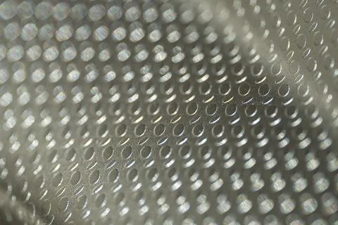 Embossed Metallic Surface with Oval Pattern Close-Up Stock Photos