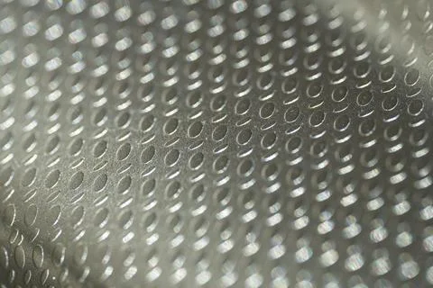 Embossed Metallic Surface with Oval Pattern Close-Up Stock Photos