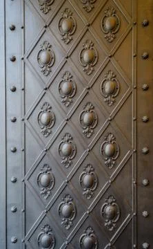 Embossed pattern on a bronze door panel Stock Photos