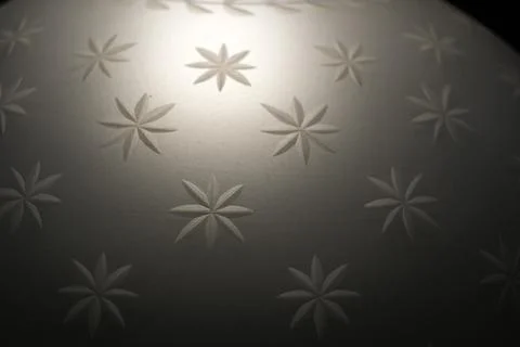 Embossed Star Flower Pattern on White Curved Surface Stock Photos
