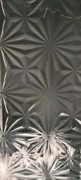 Embossed starburst patterned glass texture Stockfoto's