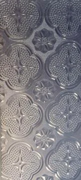 Embossed Surface with Clover and Flower Motifs Stock Photos