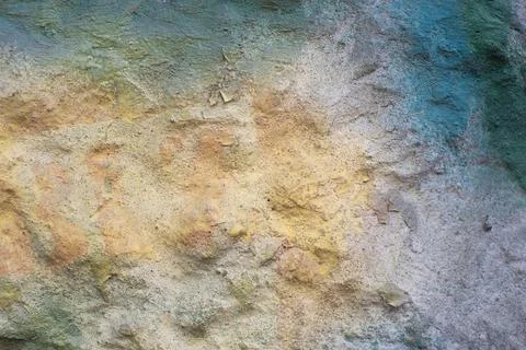 Embossed texture of rough plaster painted with spots of white, green, yellow Stock Photos