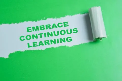 Embrace continuous learning text written in torn paper. Stock Photos