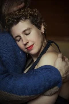 Embrace shared in a cozy indoor setting during an intimate moment between p.. Stock Photos