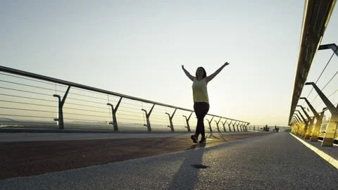 Embracing Active Mornings: Female Runner Prepares for Jogging by Stretching and Stock Footage 248990879