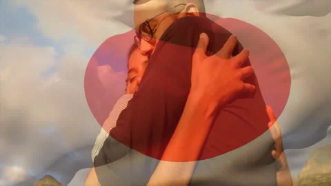 Embracing warmly, couple with animation of abstract red shape in background Stock Footage 305192995