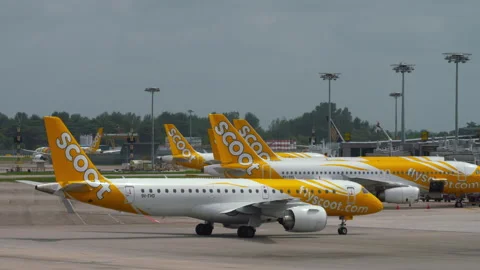 Embraer E-190 Scoot Airlines taxiing at Changi airport Stock Footage 329945496