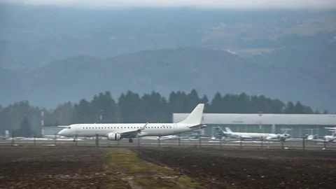 Embraer E195LR approaching and landing Stock Footage 169811725