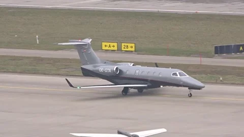 Embraer phenom 300 private jet taxiing foggy weather during wef (world economic Stock Footage 303929379