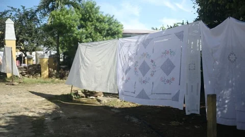 Embroided table cloths drying in the sun in Cuban summertime Stock Footage 135140192