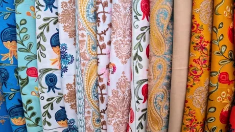 Embroidered Fabric Rolls in Vibrant Patterns at Textile Market, Swetizchoweli Stock Footage 336708018