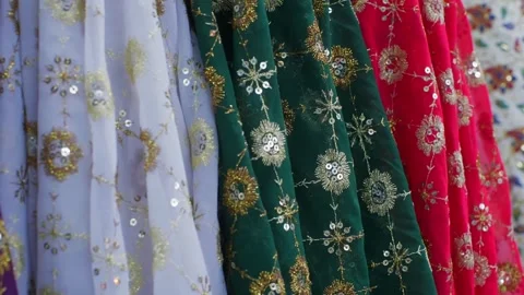 Embroidered fabrics with gold beadwork displayed in vibrant colors Video stock 337481981