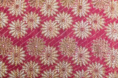 Embroidered textile oriental shiny pattern with gold threads Stock Photos