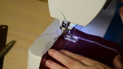 Embroidering patterns on a sewing machine machine Stock Footage 94730971