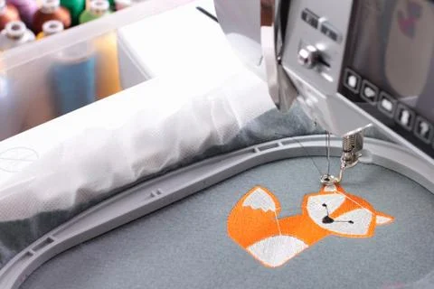 Embroidery with embroidery machine - fox theme - machine and background with  Stock Photos